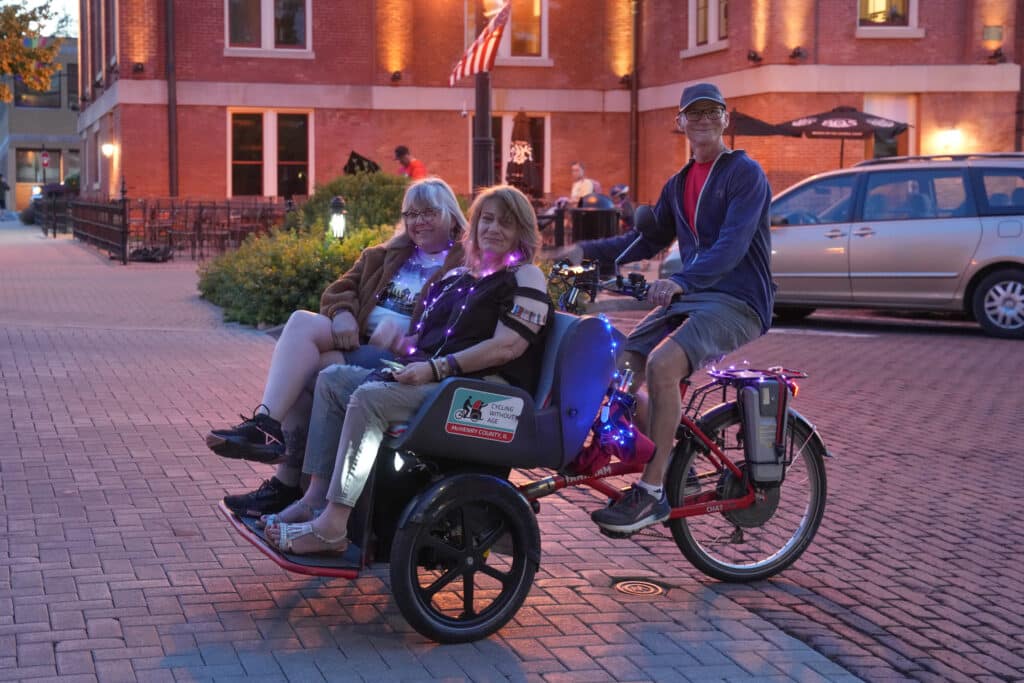 Laura Fry, Kimberly Ross (closer) and driver Myles Adamson from Cycling Without Age McHenry County