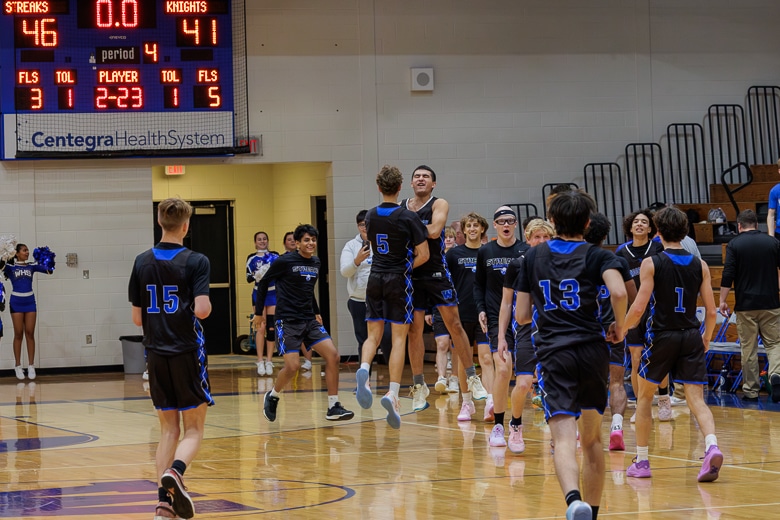 Woodstock Blue Streaks celebrate their victory over the Grays Lake North Knights on Monday night.