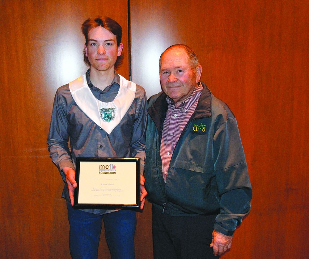 courtesy photo 
Mason Nicolai receives a scholarship certificate from Bill Cunningham, North Eastern Illinois Twin Cylinder Club Board president.