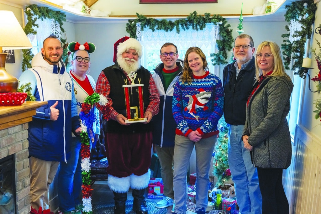 Independent photo by Andrew Rousey.
Northwood Middle School hands the Coin Wars trophy to Creekside Middle School for 2025. Pictured left to right: Creekside Principal Ryan Doyls, Northwood Principal Bethany Hall, Santa Clause, Creekside Assitant Principal Kristopher Nickolas, Northwood Assistant Principal Kelsey Murphy, Woodstock Rotary President Joseph McDonough, Woodstock Rotary Immediate Past President Laura Cullotta