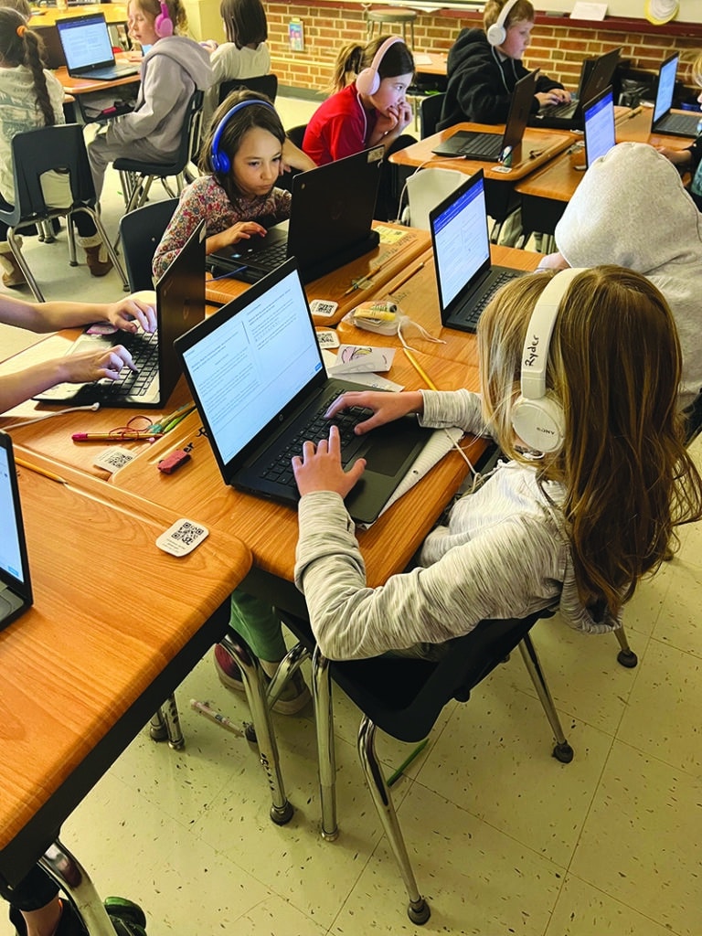 Courtesy photo.
Third-graders at Westwood Elementary School work on computers while using headphones to block out distractions. Student Ryder Cyrul is in the foreground, and Madison Wells is in the background.