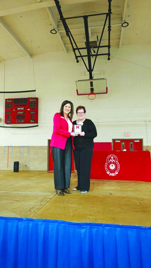 Courtesy photo.
Kaitlyn (Thompson) Bordeaux, left presents Pat Leucht, right, widow of Marian Central Catholic High School Hall of Fame member Charles Leucht, Jr., with a plaque at a school Hall of Fame ceremony Jan. 24.