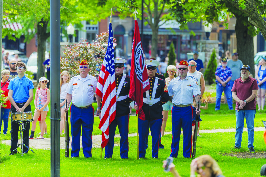 Independent photo by Andrew Rousey.
People stand for the playing of the national anthem during Memorial Day ceremonies at the Park in the Square in Woodstock.