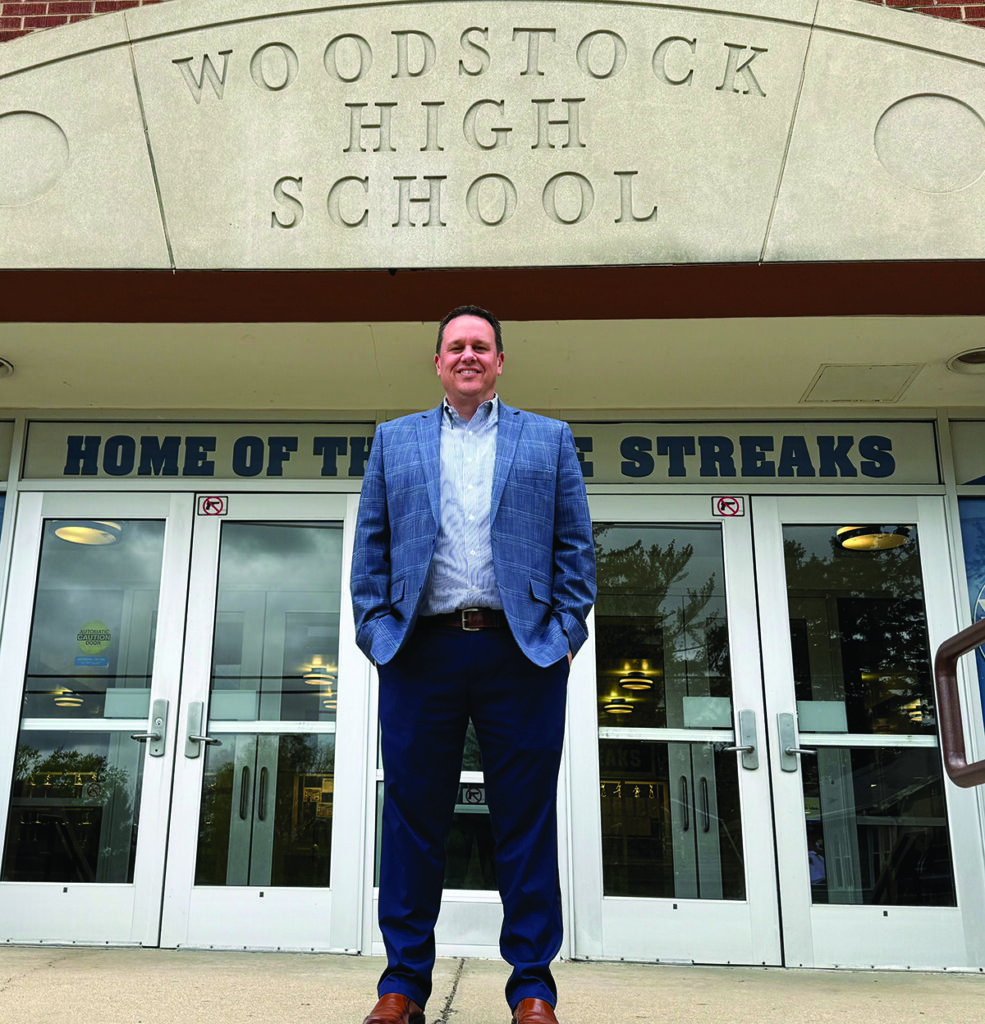 Independent photo by Eileen Millard.
Art Vallicelli stands on the steps of Woodstock High School last month.